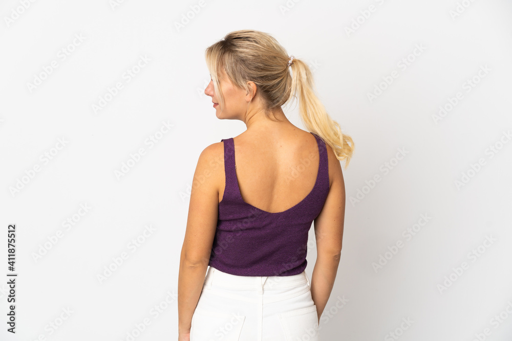 Young Russian woman isolated on white background in back position and looking side Young Russian woman isolated on white background in back position and looking side