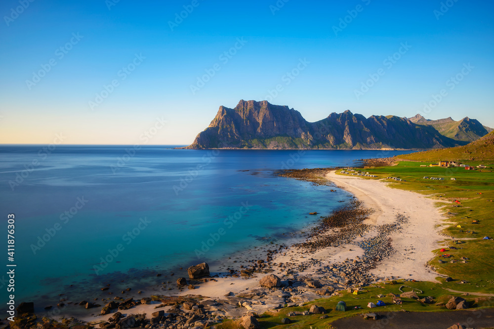 Many tents and camping cars on Uttakleiv beach in Lofoten islands, Norway