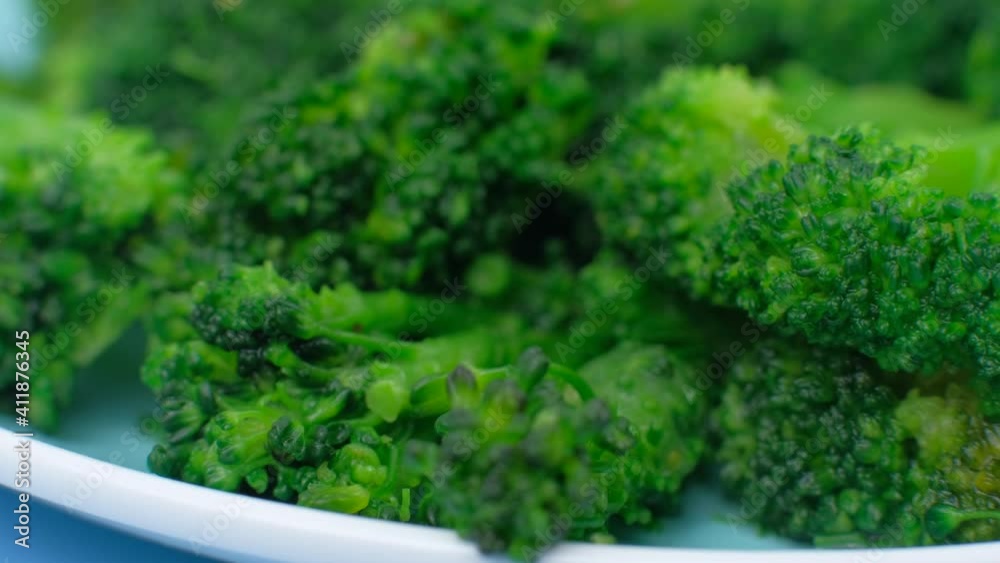 Broccoli on blue plate close up . Concept of diet food or healthy lifestyle. Vegetarianism and raw food. Broccoli on blue plate close up . Concept of diet food or healthy lifestyle. Vegetarianism and raw food.
