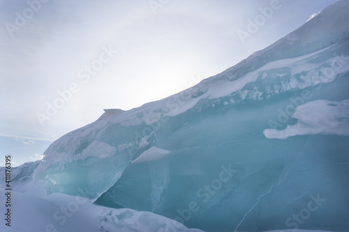 Ice hummocks on Lake Bolshoe Krasnoyarsk Krai Siberia Sunny day blue sky white snow azure ice outdoor view of ice blocks at frozen lake in winter