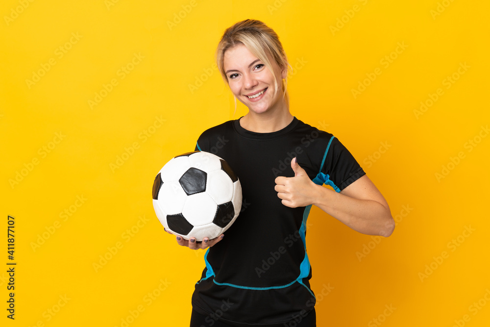 Young Russian football player woman isolated on yellow background giving a thumbs up gesture Young Russian football player woman isolated on yellow background giving a thumbs up gesture