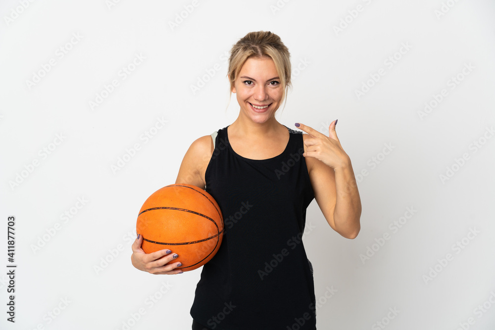 Young Russian woman playing basketball isolated on white background giving a thumbs up gesture Young Russian woman playing basketball isolated on white background giving a thumbs up gesture