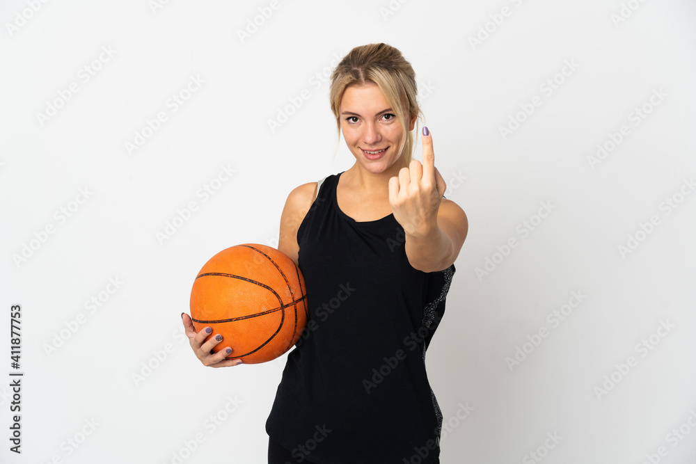 Young Russian woman playing basketball isolated on white background doing coming gesture