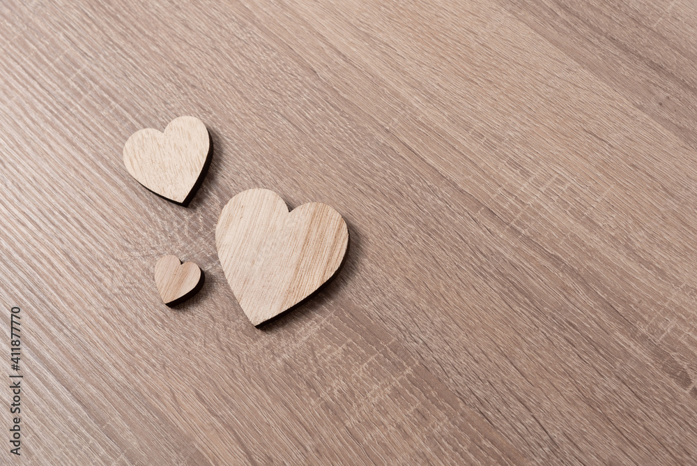 Wooden heart shapes on wood table flat lay and copy space Wooden heart shapes on wood table flat lay and copy space