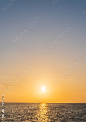 Sunset sky vertical over sea in the evening with colorful sunlight, Dusk sky. © Nature Peaceful 