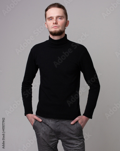 serious man in a black sweater