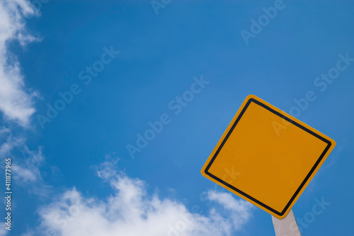 Blank yellow warning board in the clearly sky