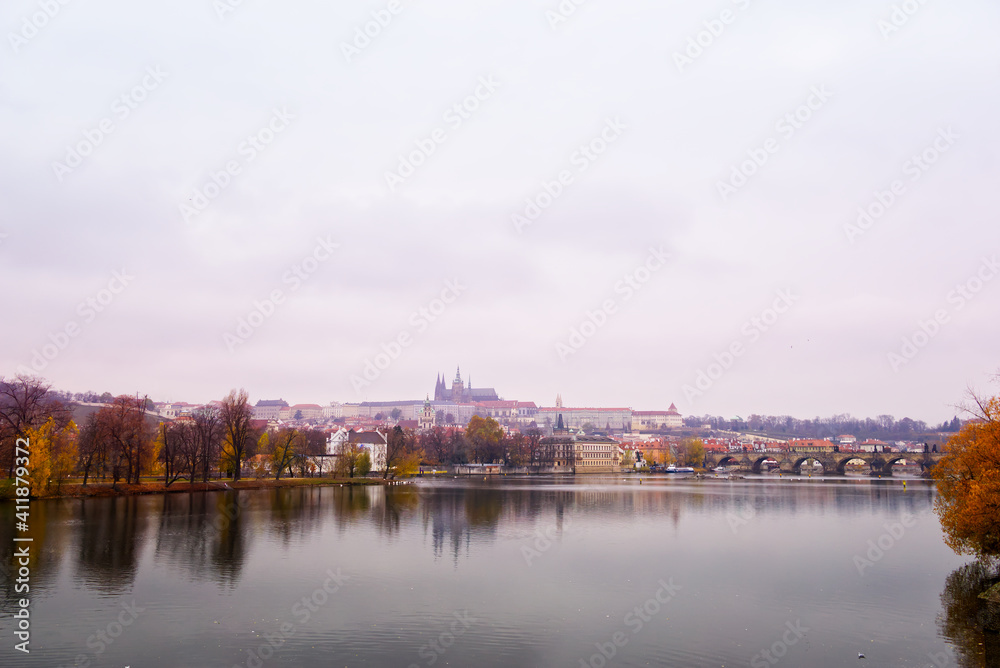 Panoramic view of the Vltava river with the city of Prague and the cathedral saint Guy in background. The Charles bridge is at the right.