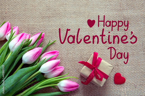 Valentine's day background with pink tulips and present