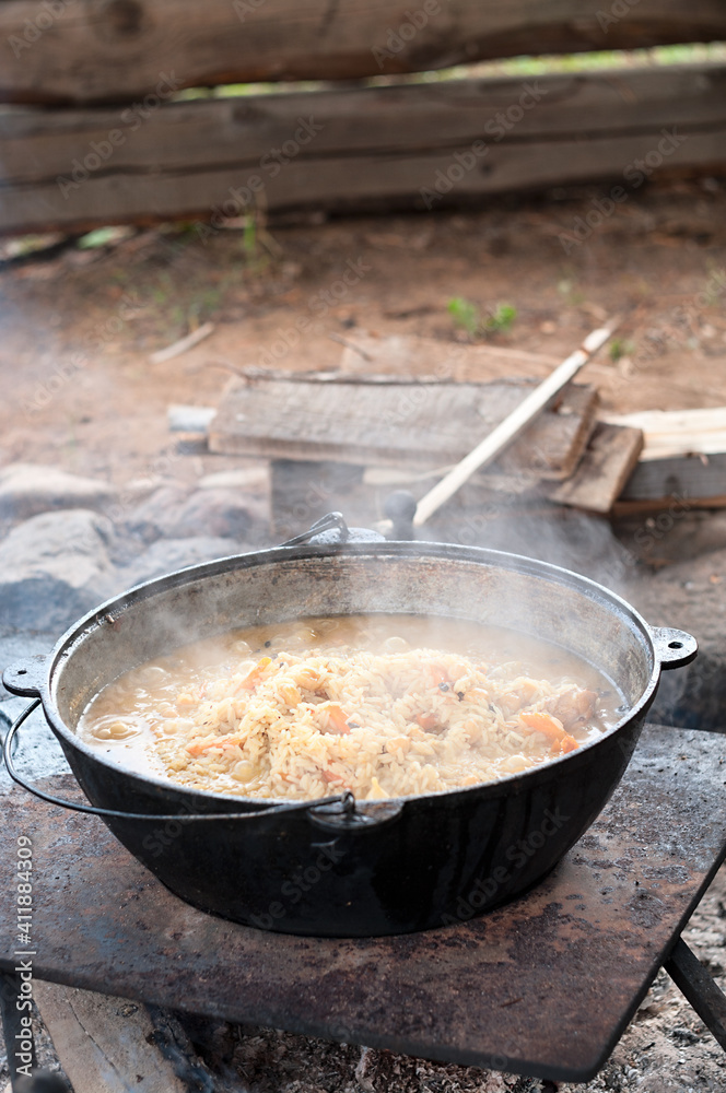 Smoking cauldron with pilaff cooking. Vertical image, series Smoking cauldron with pilaff cooking. Vertical image, series