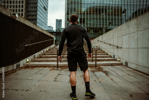 Caucasian male athlete preparing to run up stairs in city fitness training for marathon