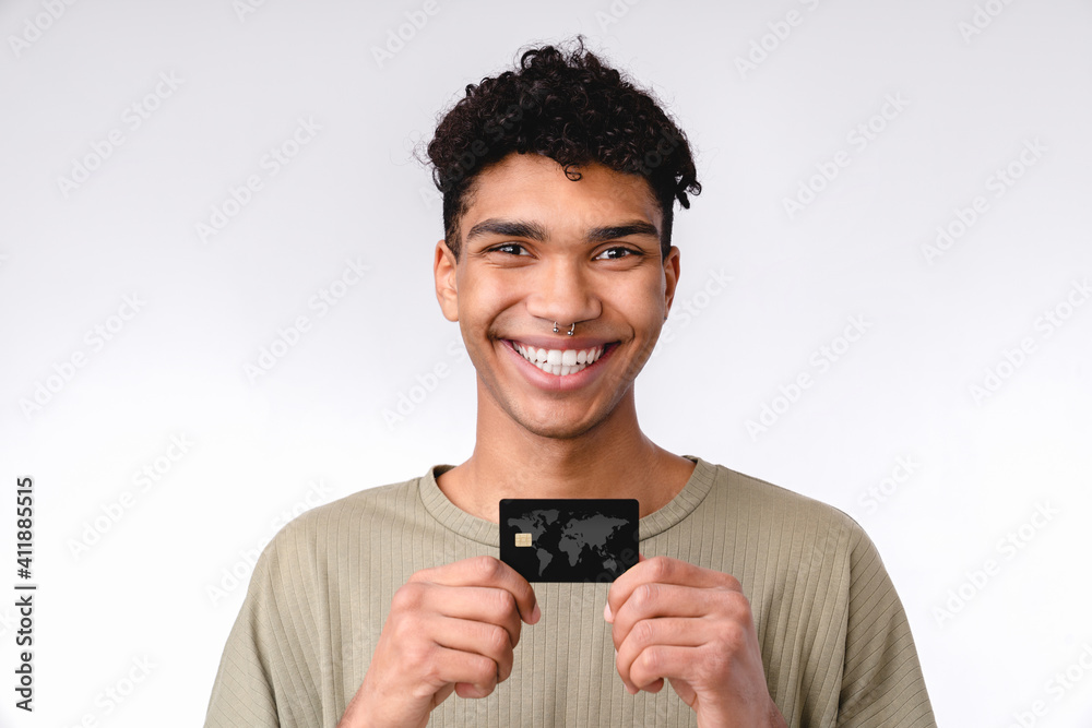 Smiling young african student showing credit card isolated over white background Smiling young african student showing credit card isolated over white background