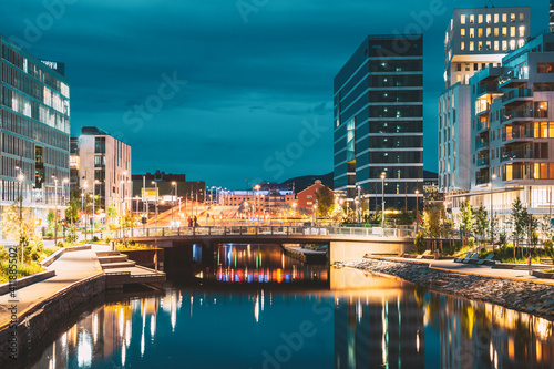 Oslo, Norway. Night View Embankment And Residential Multi-storey House In Gamle Oslo District. Summer Evening. Residential Area Reflected In Sea Waters © Grigory Bruev