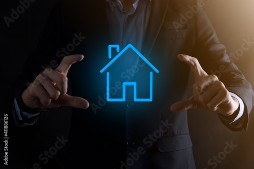 Real estate concept  businessman holding a house icon.House on Hand.Property insurance and security concept. Protecting gesture of man and symbol of house.