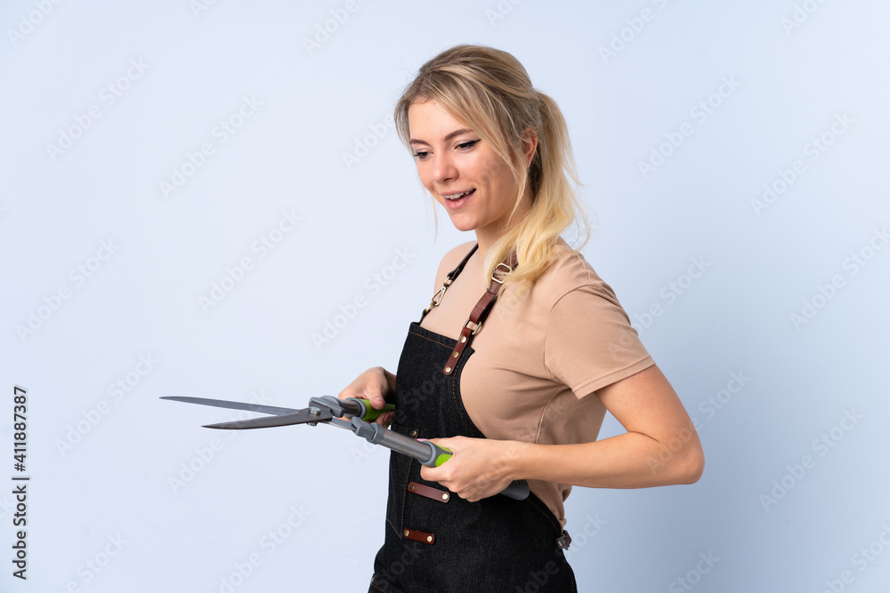 Blonde gardener woman over isolated background Blonde gardener woman over isolated background