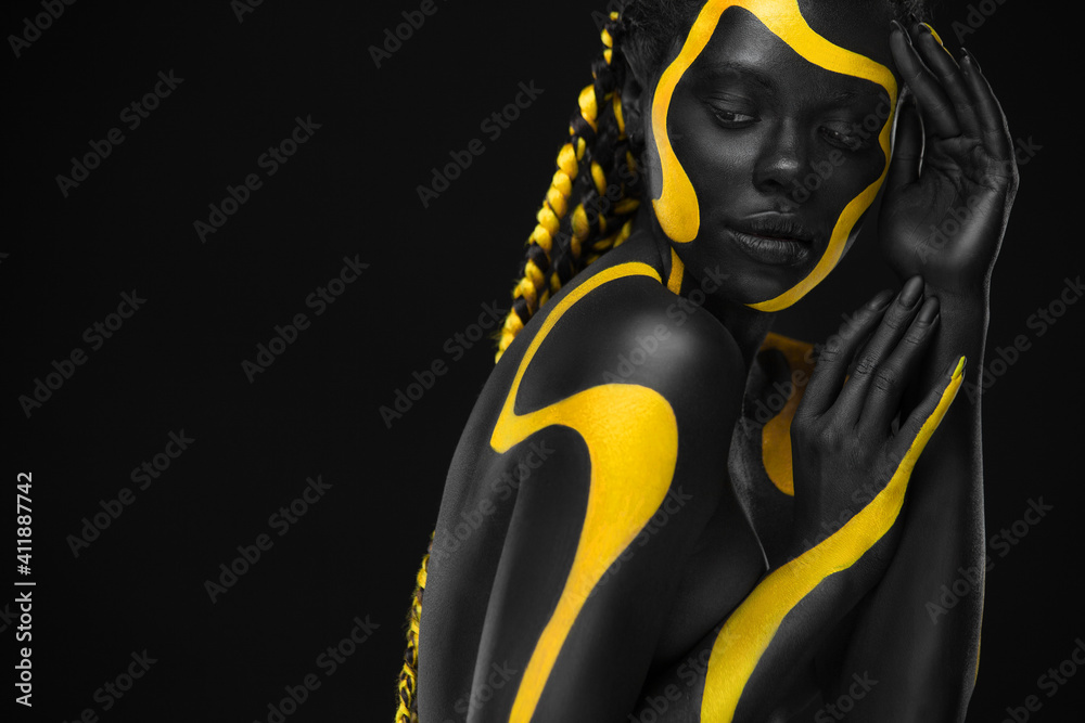 Yellow and black body paint. Woman with face art. Young girl with colorful  bodypaint. An amazing afro american model with makeup. Stock Photo by  ©MikeOrlov 528582600