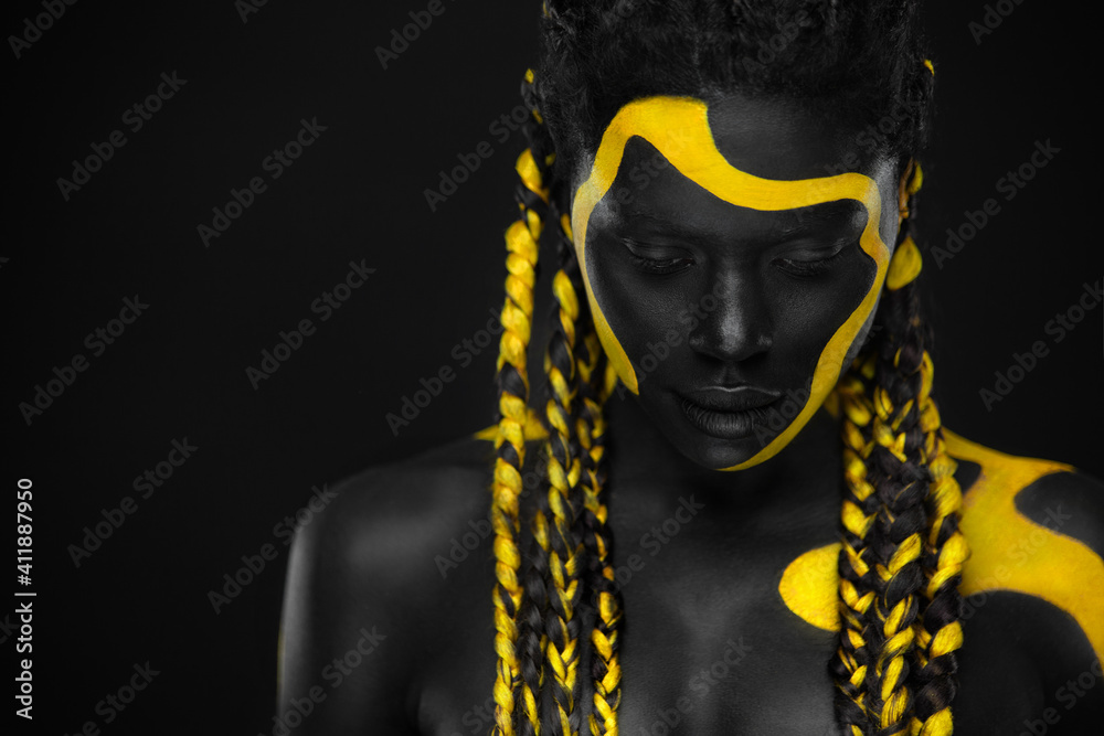 Yellow and black body paint. Woman with face art. Young girl with colorful  bodypaint. An amazing afro american model with makeup. Stock Photo by  ©MikeOrlov 528582600