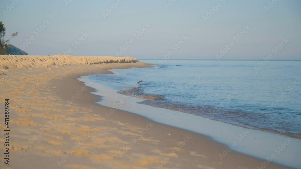Waves rolling up sand sea beach at summer day. Slow motion. Waves rolling up sand sea beach at summer day. Slow motion.