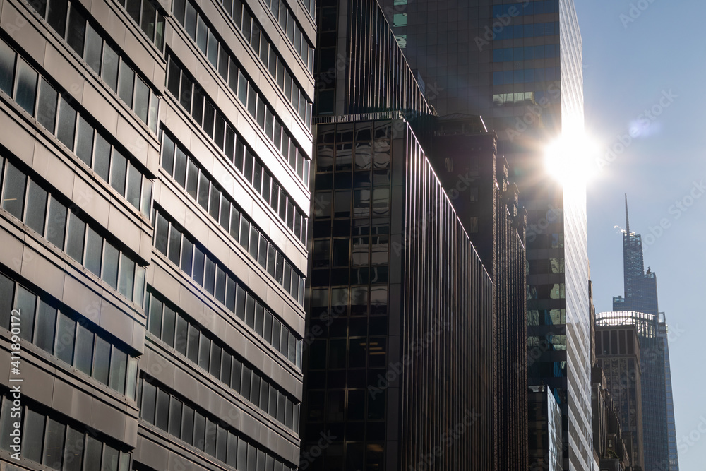 Row of Modern Office Buildings on a Street in Midtown Manhattan with Sunshine in New York City