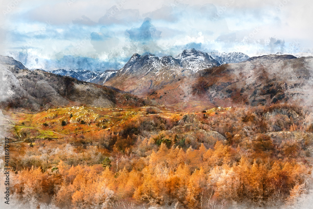 Majestic Winter landscape image view from Holme Fell in Lake District towards snow capped mountain ranges in distance in glorious evening light with Autumnal colors trees