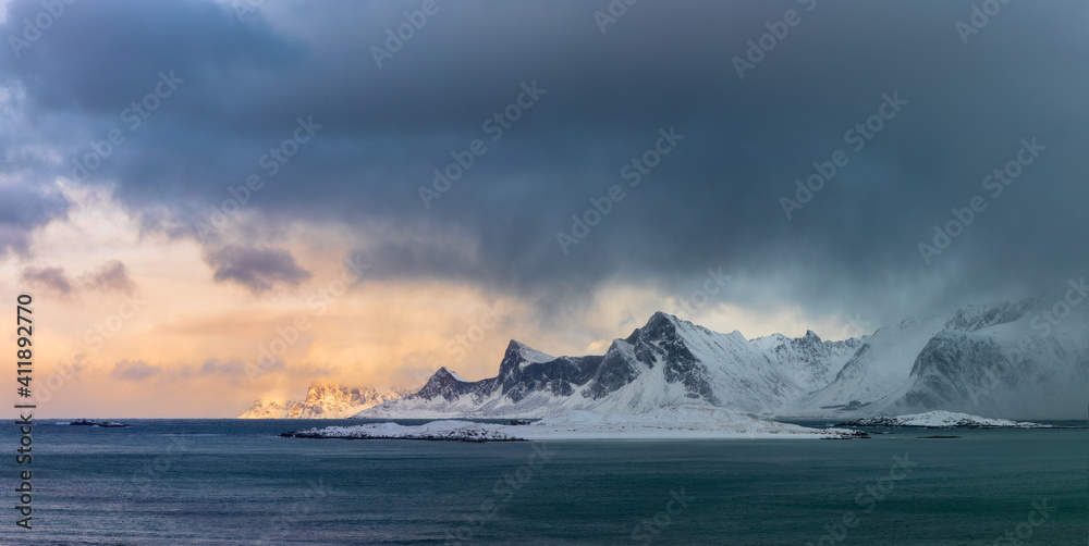 Panoramic landscape of winter mountains, dramatic sky and sea. Lofoten islands, Norway