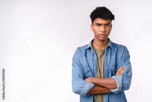 Offended young mixed-race man in casual clothes isolated over white background