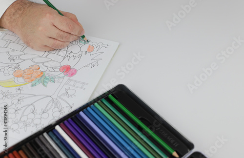 Drawing mandala anti stress with multicoloured pencils during lockdown. © Olesia Prokoshina