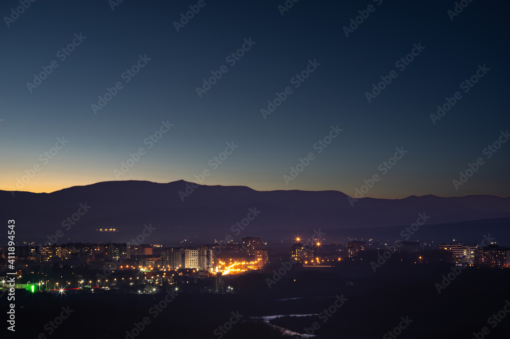 City in the background of mountains and river at sunrise