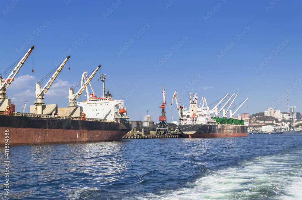 view from the sea on cargo cranes and freight ships