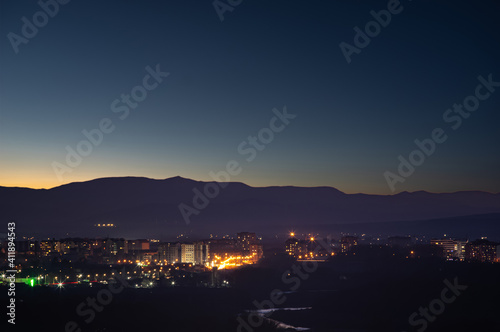 City in the background of mountains and river at sunrise