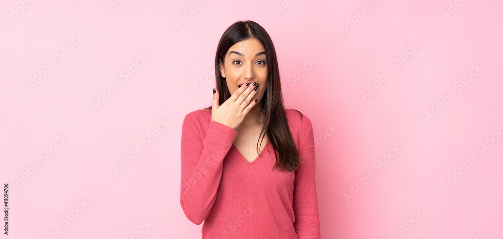 Young caucasian woman over isolated background happy and smiling covering mouth with hand Young caucasian woman over isolated background happy and smiling covering mouth with hand
