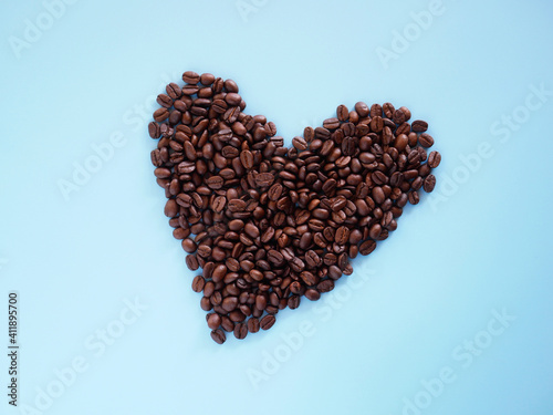 heart of coffee beans on blue background