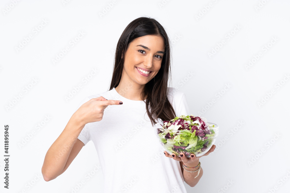 Young woman with salad isolated on white background Young woman with salad isolated on white background