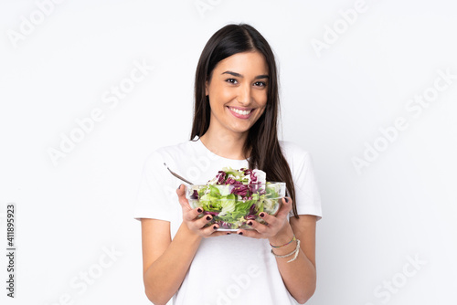Young woman with salad isolated on white background