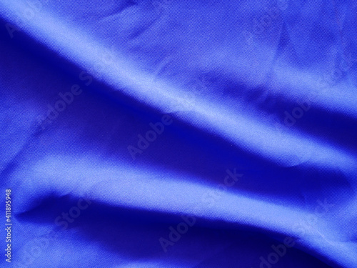 Smooth elegant dark blue silk textured background.