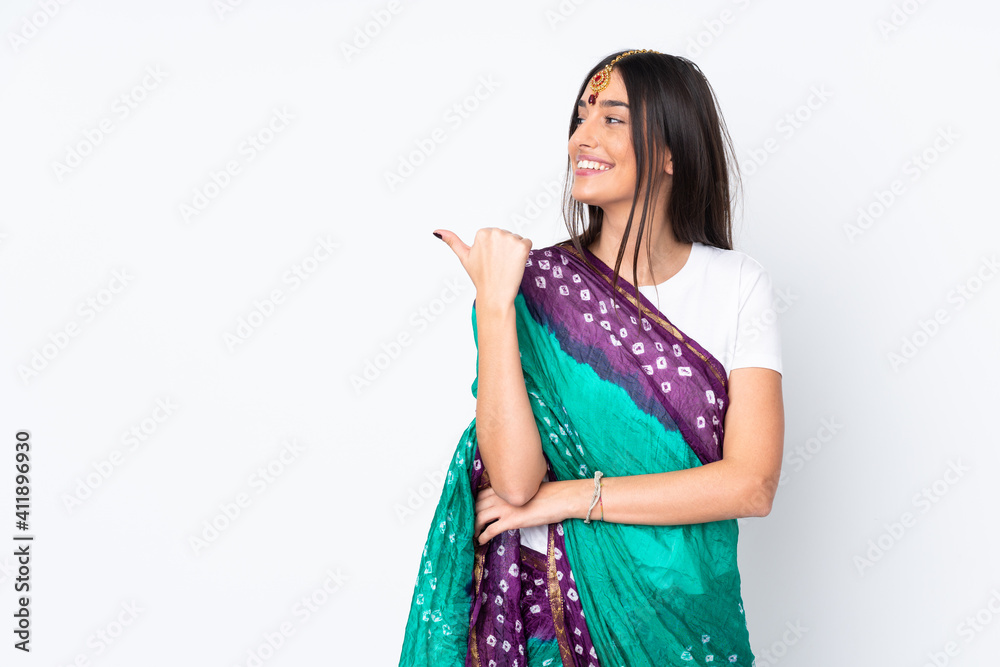 Young Indian woman isolated on white background pointing to the side to present a product Young Indian woman isolated on white background pointing to the side to present a product