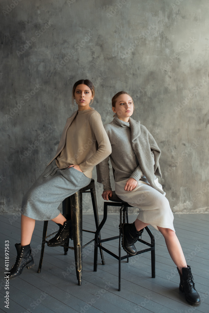 two girls in a gray sweater two girls in a gray sweater