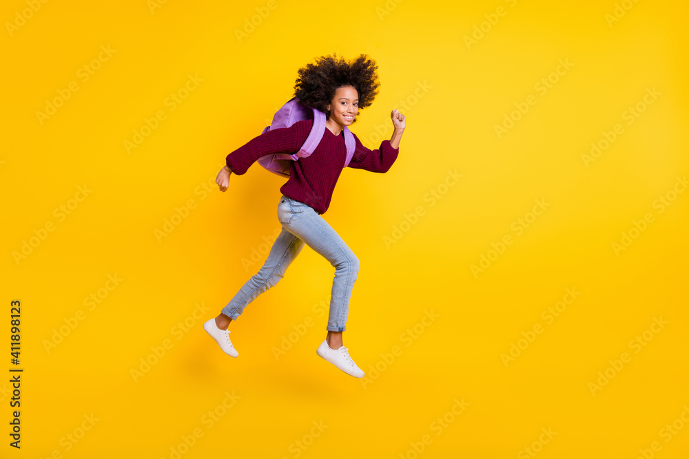 Full size profile portrait of nice dark skin pupil running carry bag wear pullover isolated on yellow color background