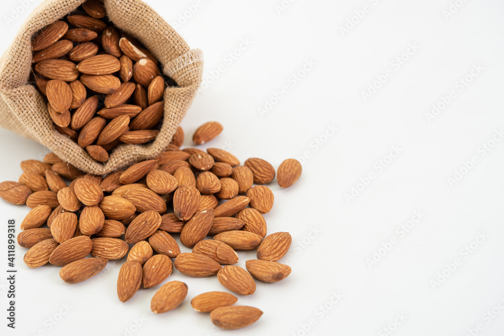 Sack with almond on white background. (selective focus; close-up shot) Sack with almond on white background. (selective focus; close-up shot)