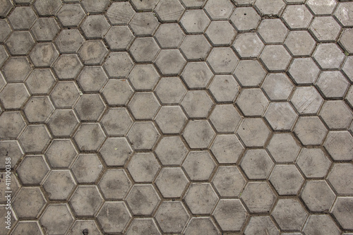 the road is paved with hexagonal paving tiles.