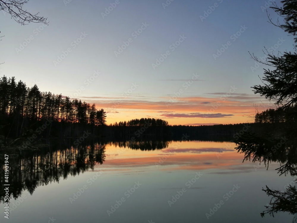 sunset on the lake with a pink sky and the beautiful reflection in the lake