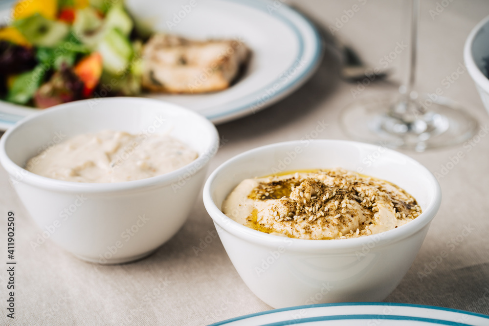 Hummus and baba ghanoush on the kitchen table. Close up Hummus and baba ghanoush on the kitchen table. Close up