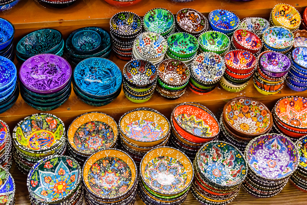 Many colorful souvenir plates for sale at the bazaar in Turkey