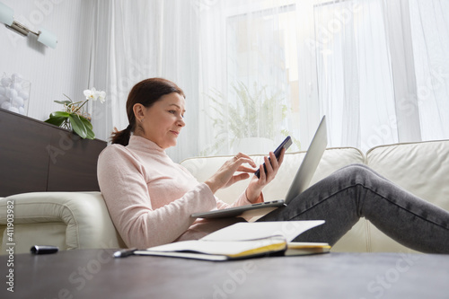 Senior mature older woman watching business training, online webinar on laptop computer remote working or social distance learning from home