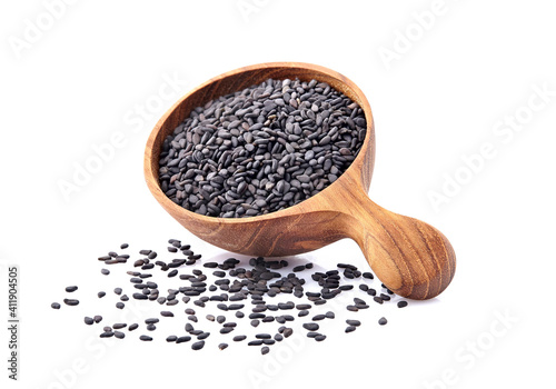 Black Sesame seeds in wooden spoon isolated on white background