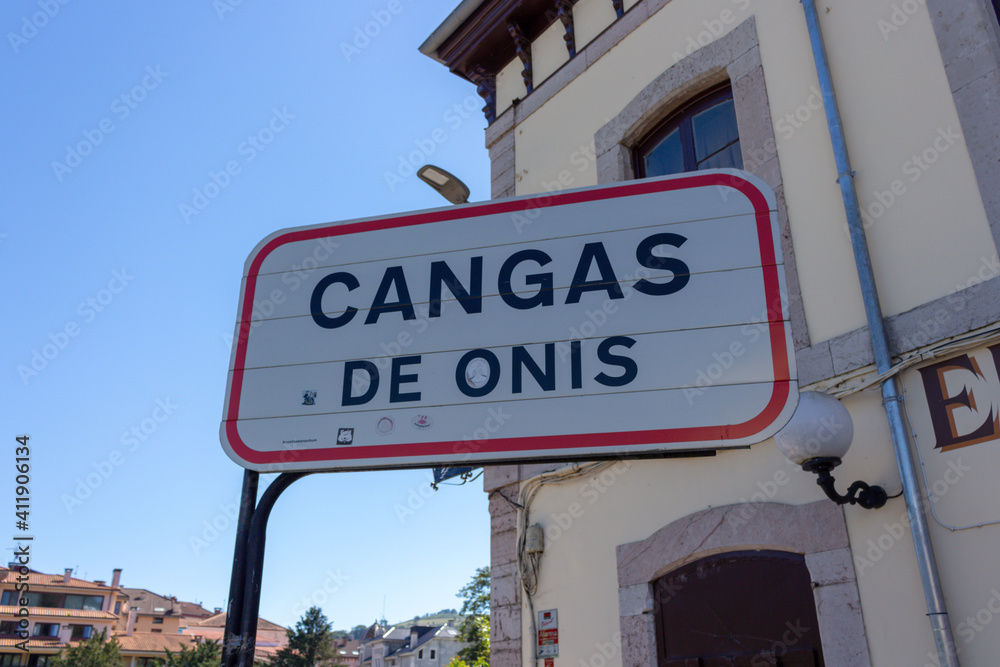 Fototapeta premium Cangas de Onis, Spain - September 4, 2020: Spanish Road Signs. Traffic sign on the road indicating the entrance to the village. Cangas de Onis city limit road sign.