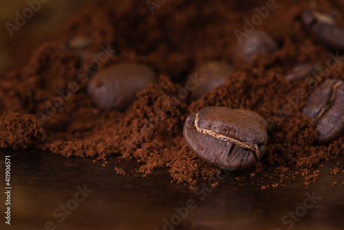 Roasted coffee beans and ground on brown roaster background