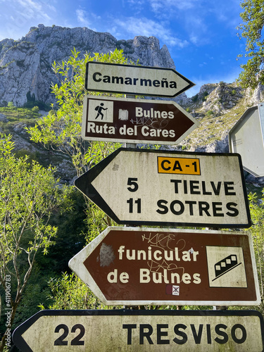 Poncebos, Spain - September 1, 2020: Spanish Road Signs. Street signs at Poncebos. Traffic directions to touristic points. Indicating to Bulnes, Tielve, Sotres, Funicular de Bulnes, Ruta del Cares. photo