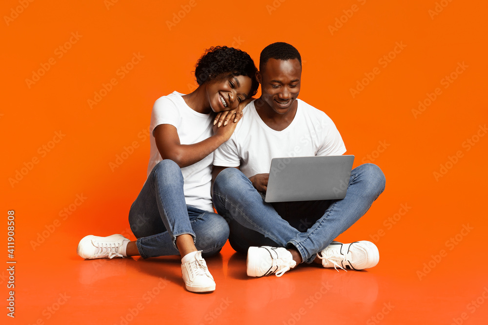 Carefree african american couple using laptop together Carefree african american couple using laptop together