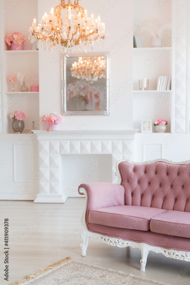 Fototapeta premium Luxury rich living room interior design with elegant classic furniture and wall decorations. Large light white room with big window and fireplace.